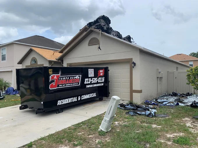 Roll-off dumpster at roofing job site Tampa Bay