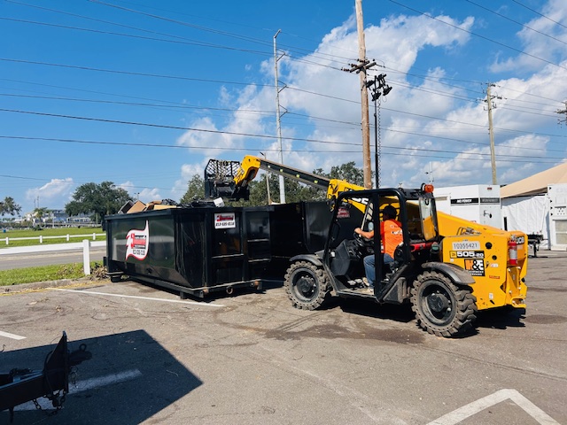 Heavy equipment and dumpster on Tampa Bay job site