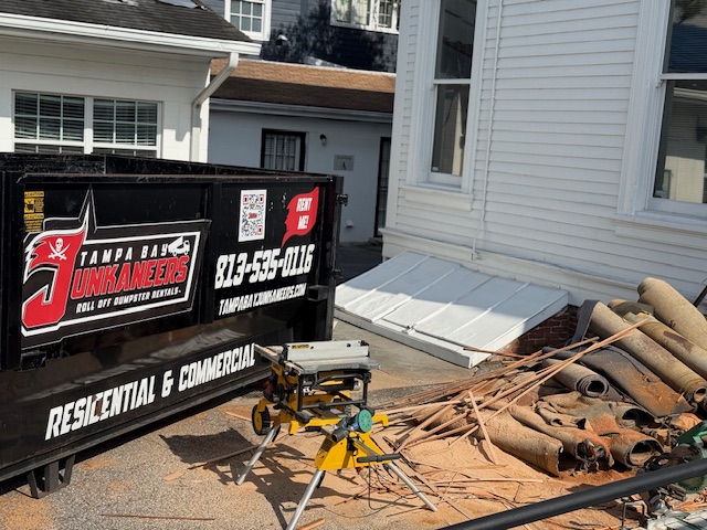 Tampa Bay Junkaneers branded dumpster on a Hillsborough County job site